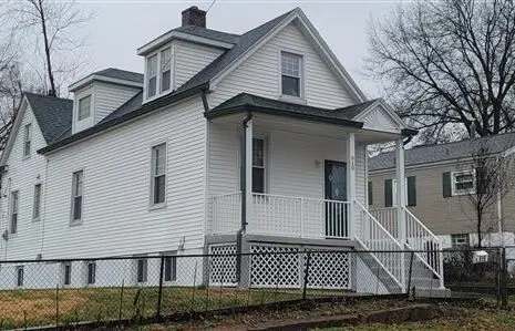 White two-story home with dormers and a front porch